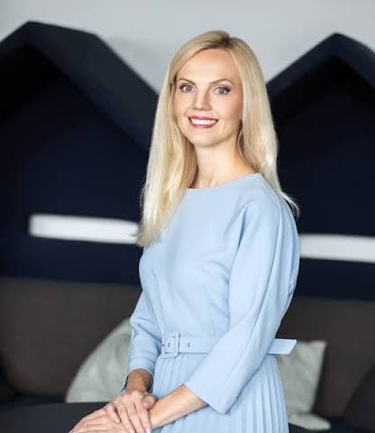 Eneli Kirs, skincare scientist and founder of Scientific Skin, in a light blue dress